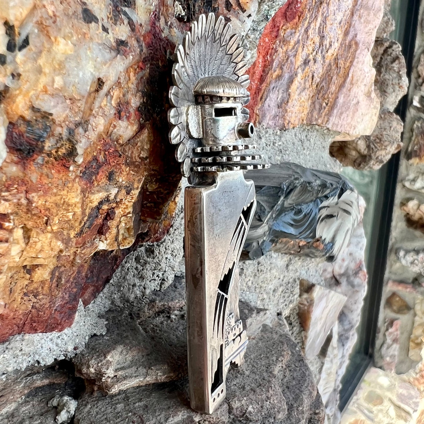 A Morning Singer kachina doll pendant made from sterling silver by Navajo artist Bennie Ration.