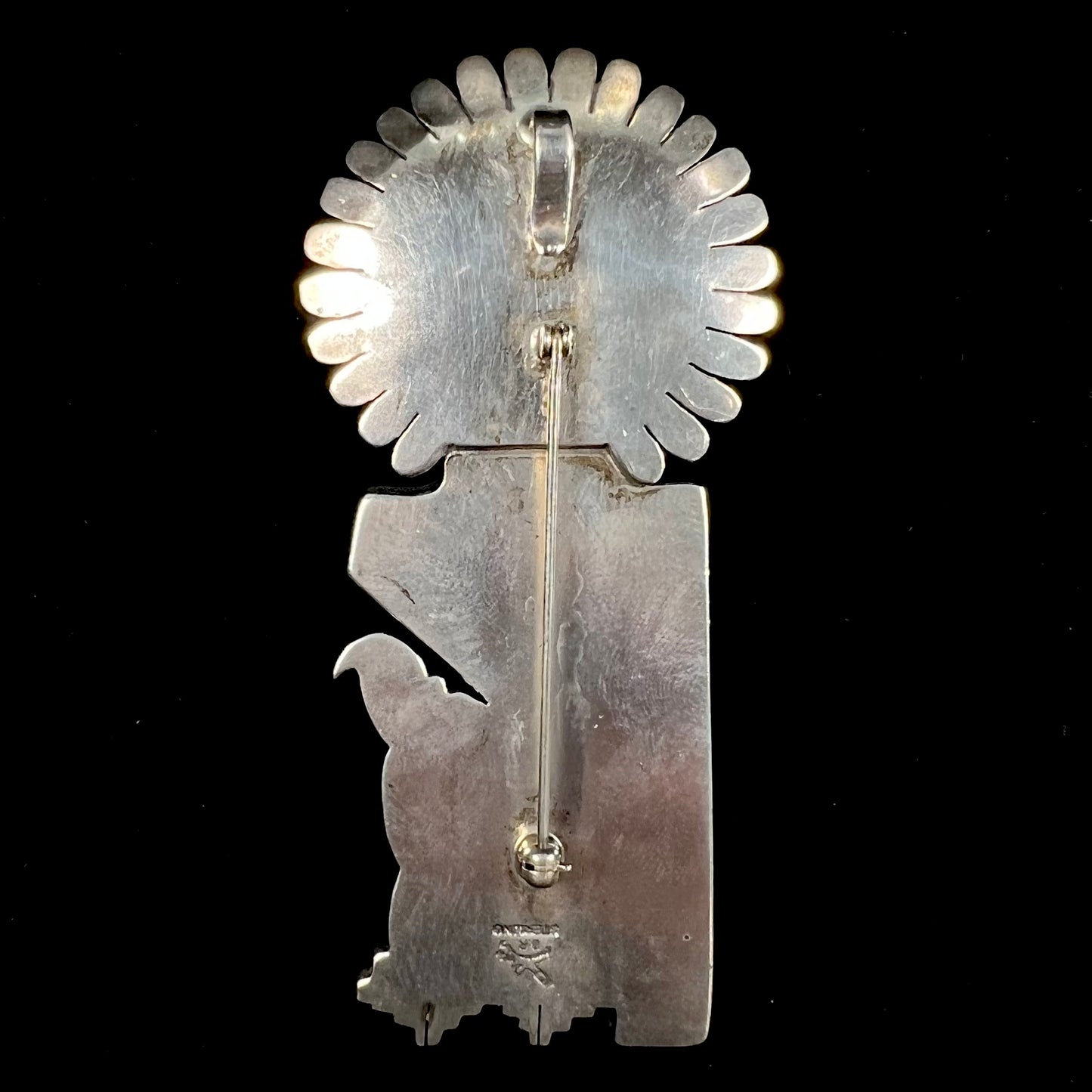 A Morning Singer kachina doll pendant made from sterling silver by Navajo artist Bennie Ration.