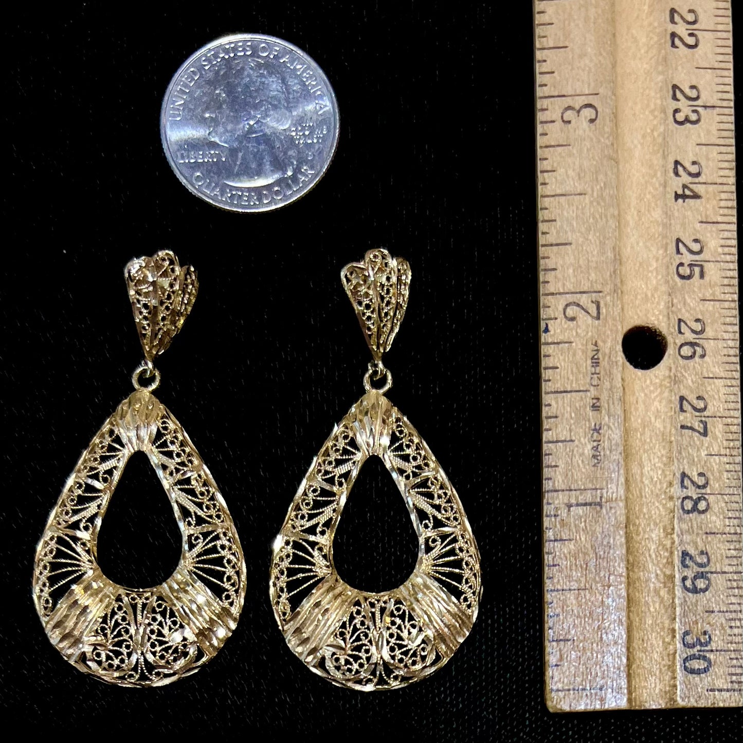 A pair of 14kt yellow gold filigree dangle earrings.  The earrings have a pear shape open design.