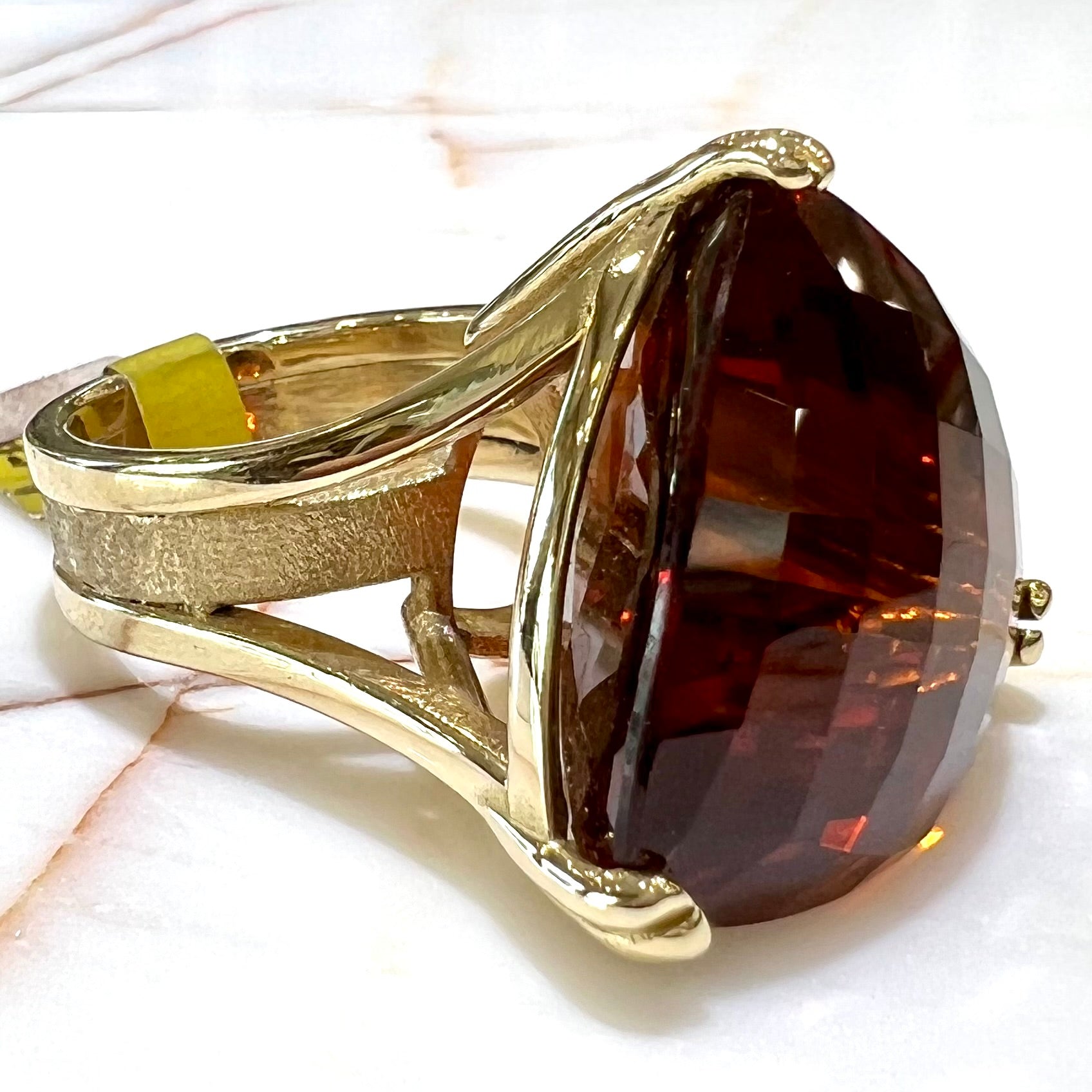 A ladies' trillion cut madeira citrine cocktail ring handmade in yellow gold.
