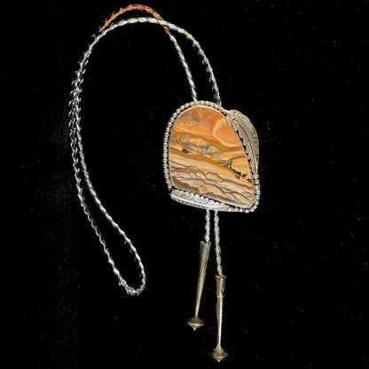 A men's sterling silver bolo tie set with a Biggs picture jasper stone.