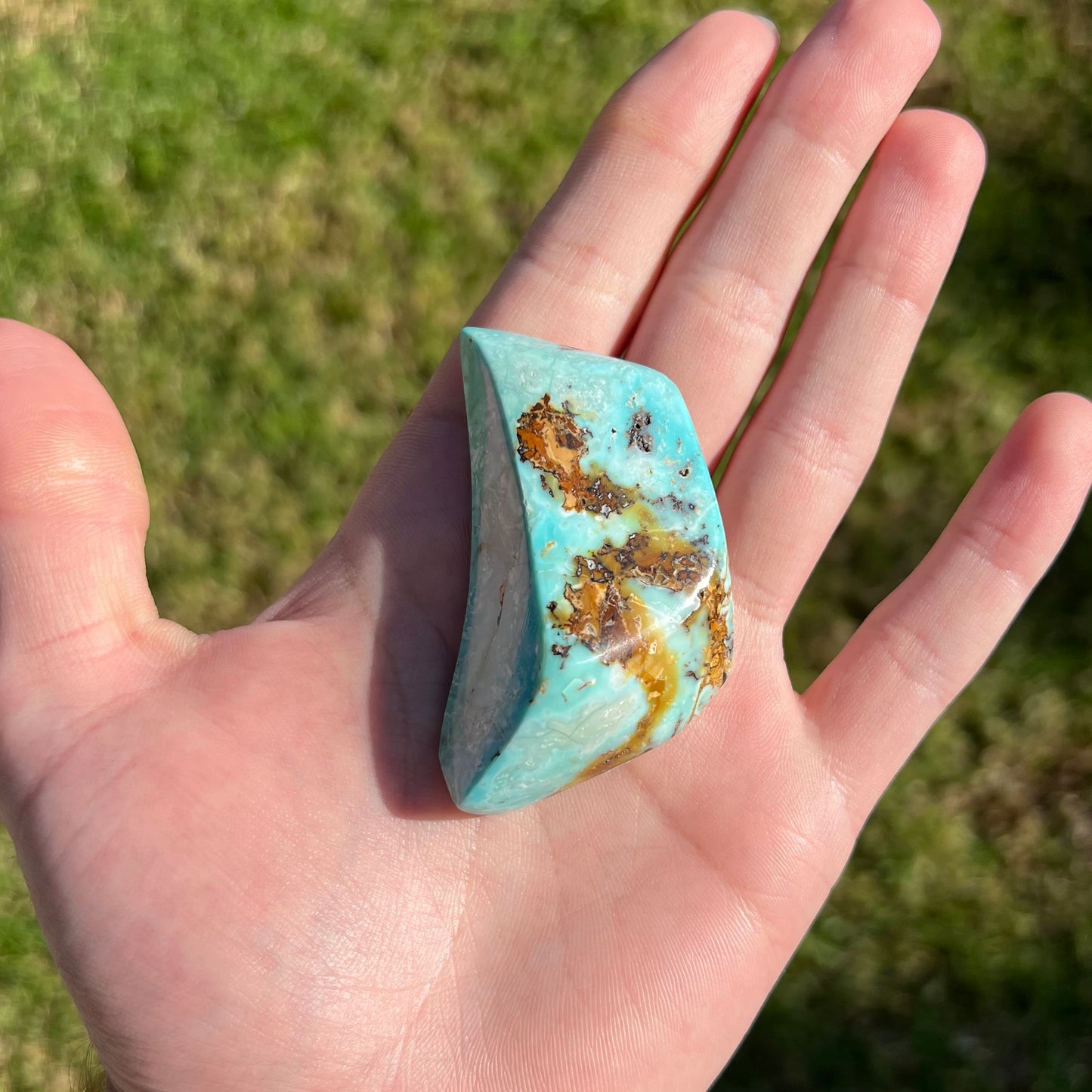 A polished, freeform shape light blue turquoise stone from Blue Gem Mine, Nevada.