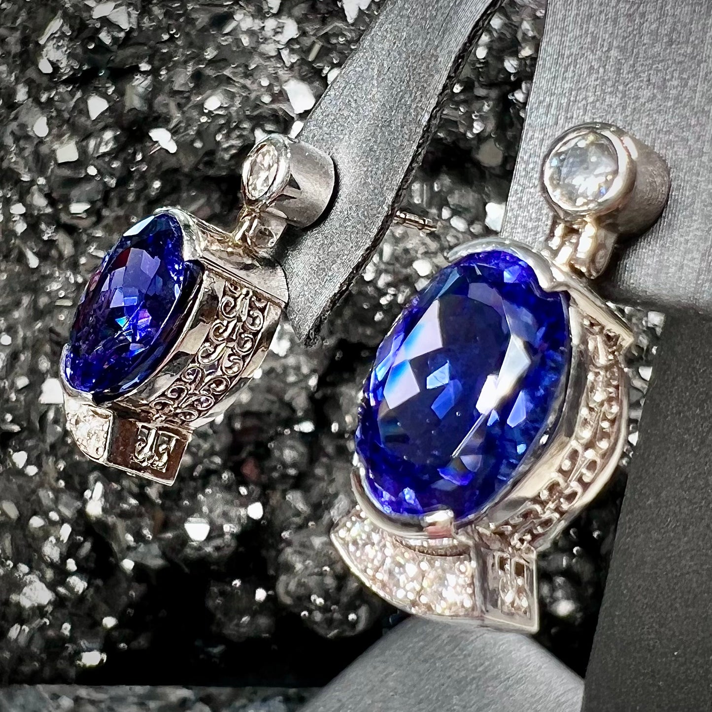 A pair of white gold, AAA grade tanzanite & diamond dangle earrings.