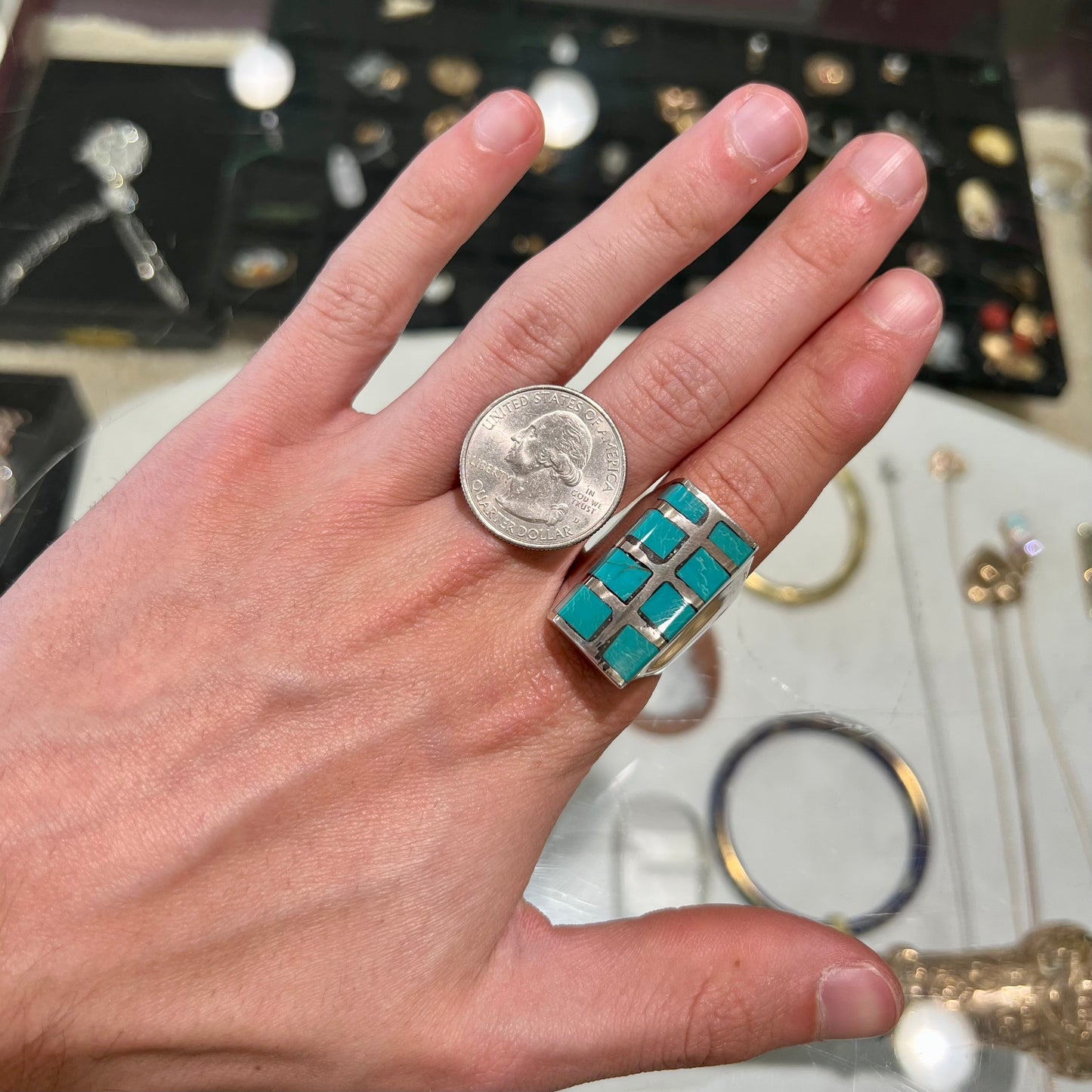 A men's sterling silver turquoise inlay ring, circa 1970.  The piece is set with 8 stones.