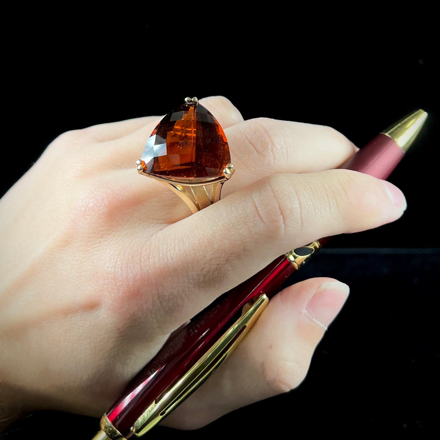 A ladies' trillion cut madeira citrine cocktail ring handmade in yellow gold.