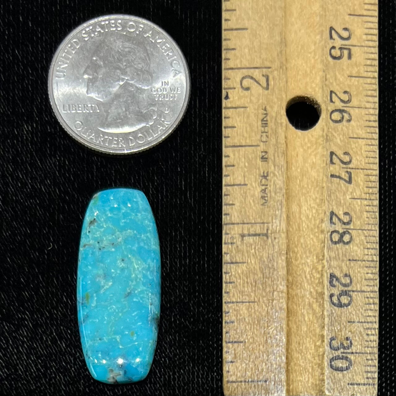 A loose, barrel shape, cabochon cut blue turquoise stone from Bisbee, Arizona.