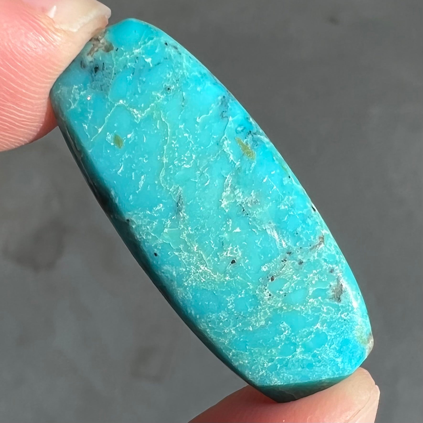 A loose, barrel shape, cabochon cut blue turquoise stone from Bisbee, Arizona.