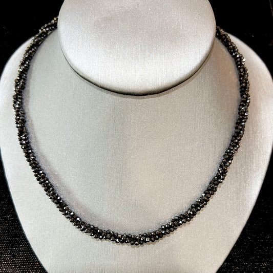 A beaded necklace made of black spinel.