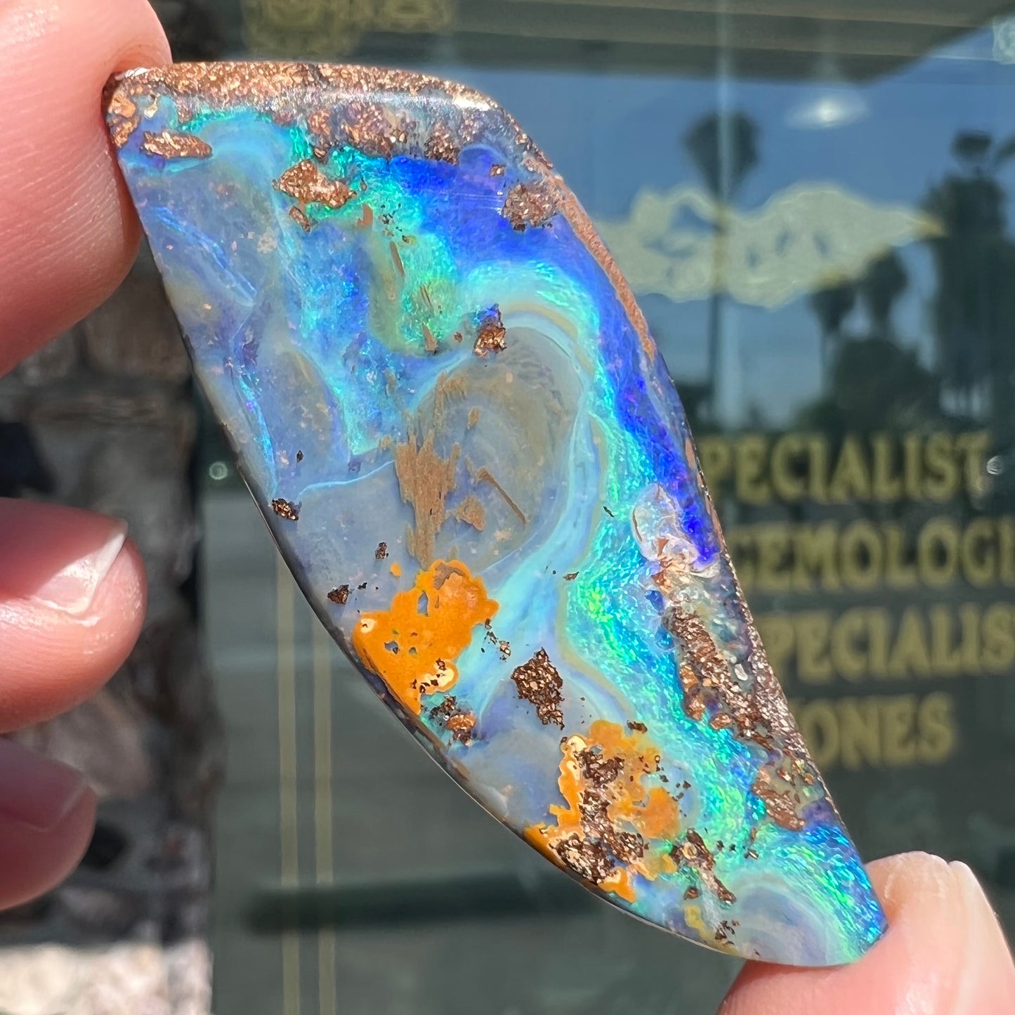 A freeform cut, loose black boulder opal stone from Queensland, Australia.