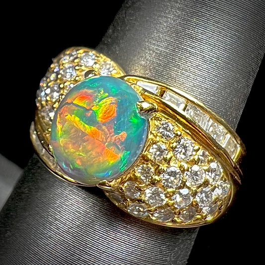 A natural, Australian black opal and diamond ring cast in 18 karat yellow gold..