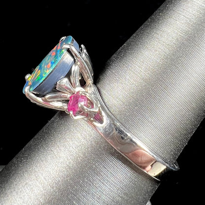 A ladies' 14kt white gold Australian black boulder opal doublet ring set with two round cut rubies.