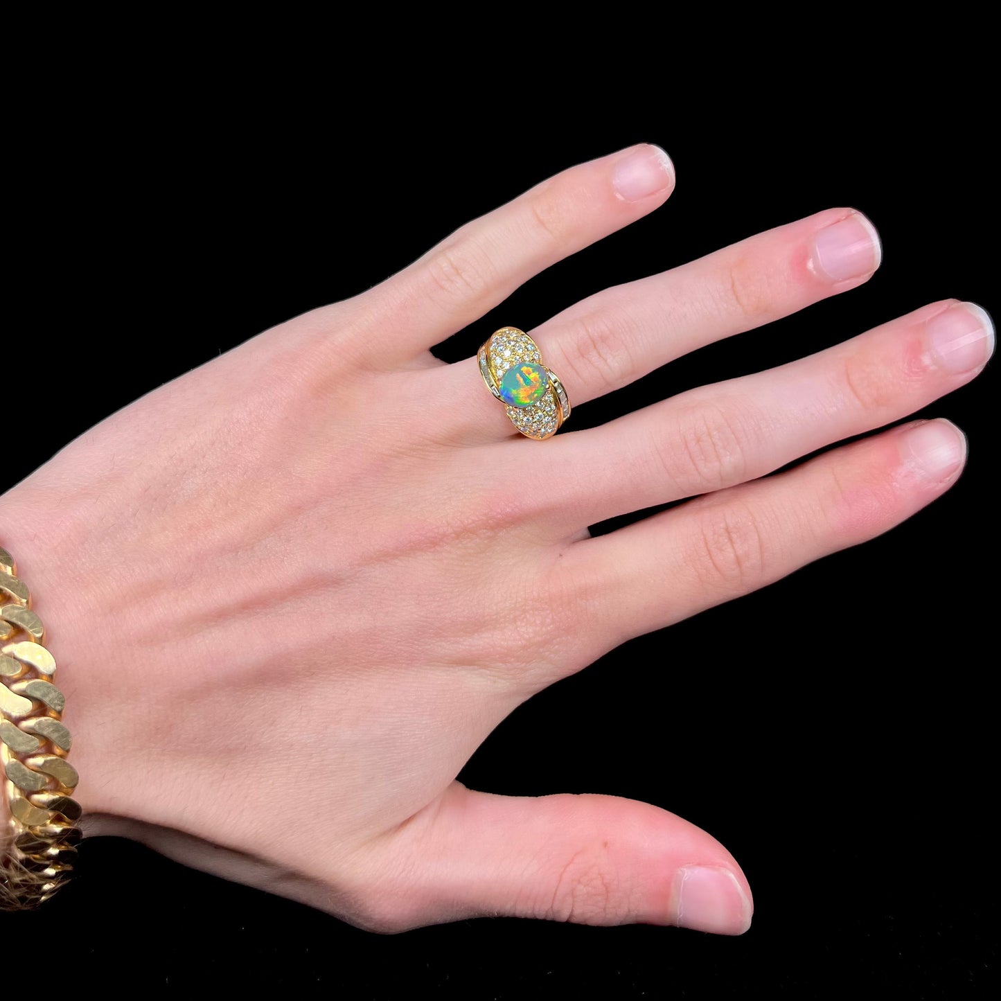 A natural, Australian black opal and diamond ring cast in 18 karat yellow gold..