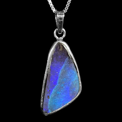 A ladies' sterling silver necklace bezel set with a triangle drop shaped Australian black boulder opal.