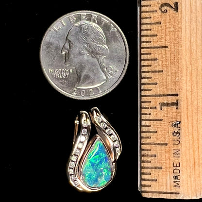 A ladies' yellow gold slider pendant set with a pear shaped Lightning Ridge, Australian black crystal opal and diamonds.