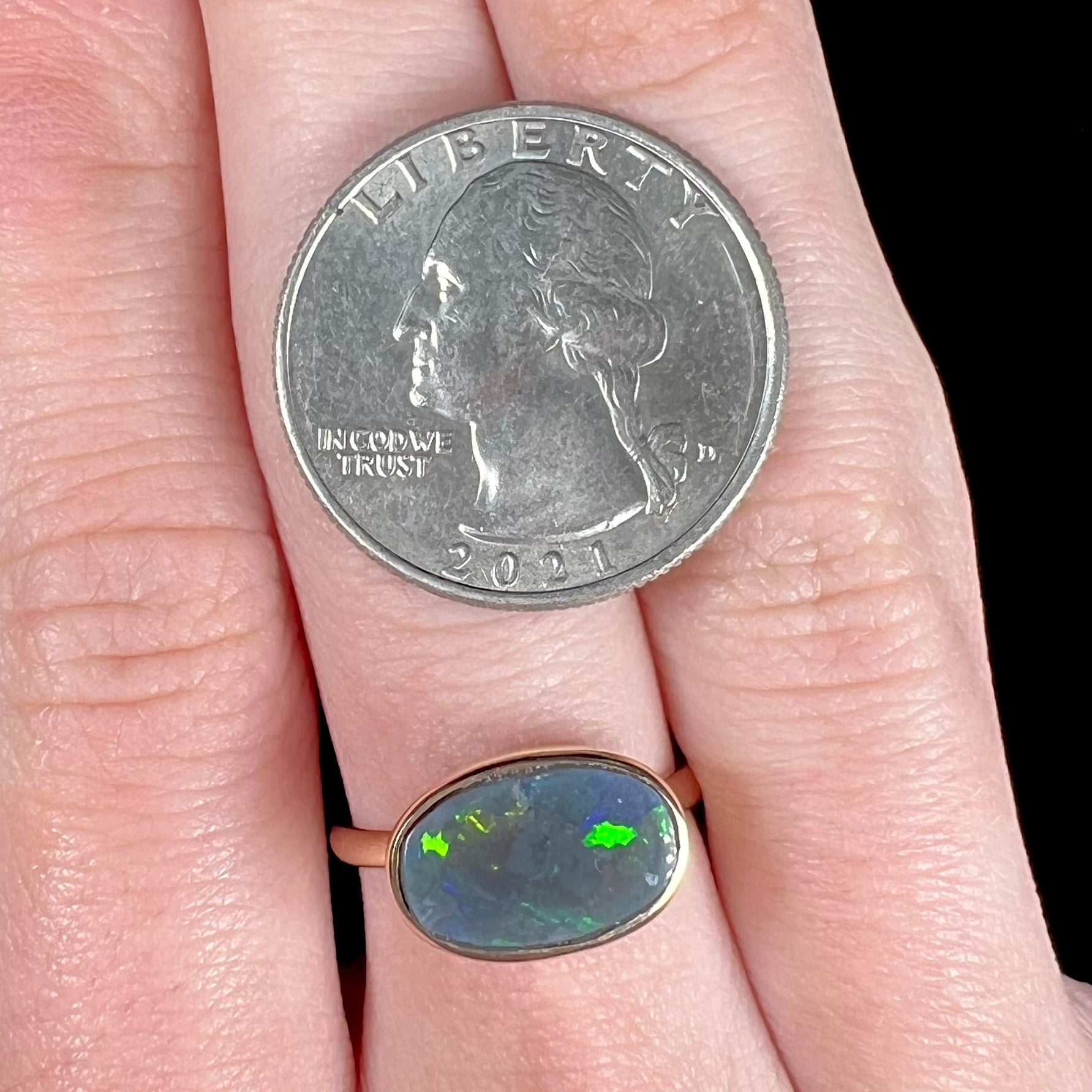 A ladies' yellow gold black opal solitaire ring from Lightning Ridge, Australia.