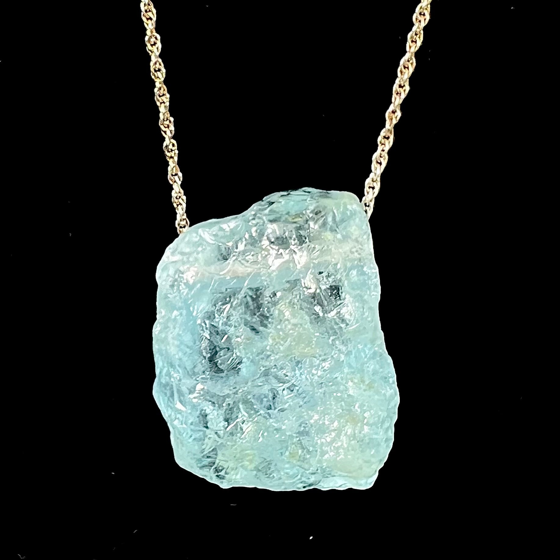 A drilled aquamarine crystal necklace on a silver wheat chain.