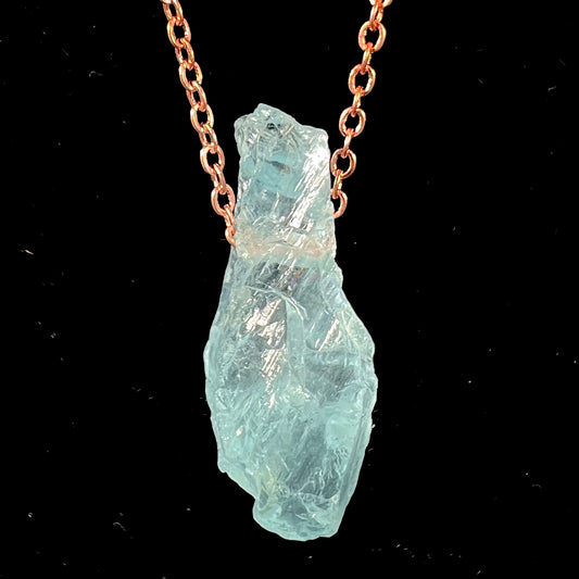 A drilled aquamarine crystal necklace on a copper cable chain.