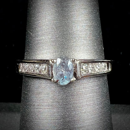 A ladies' white gold and diamond ring set with a 0.26ct alexandrite center stone that changes from green blue to lilac purple.