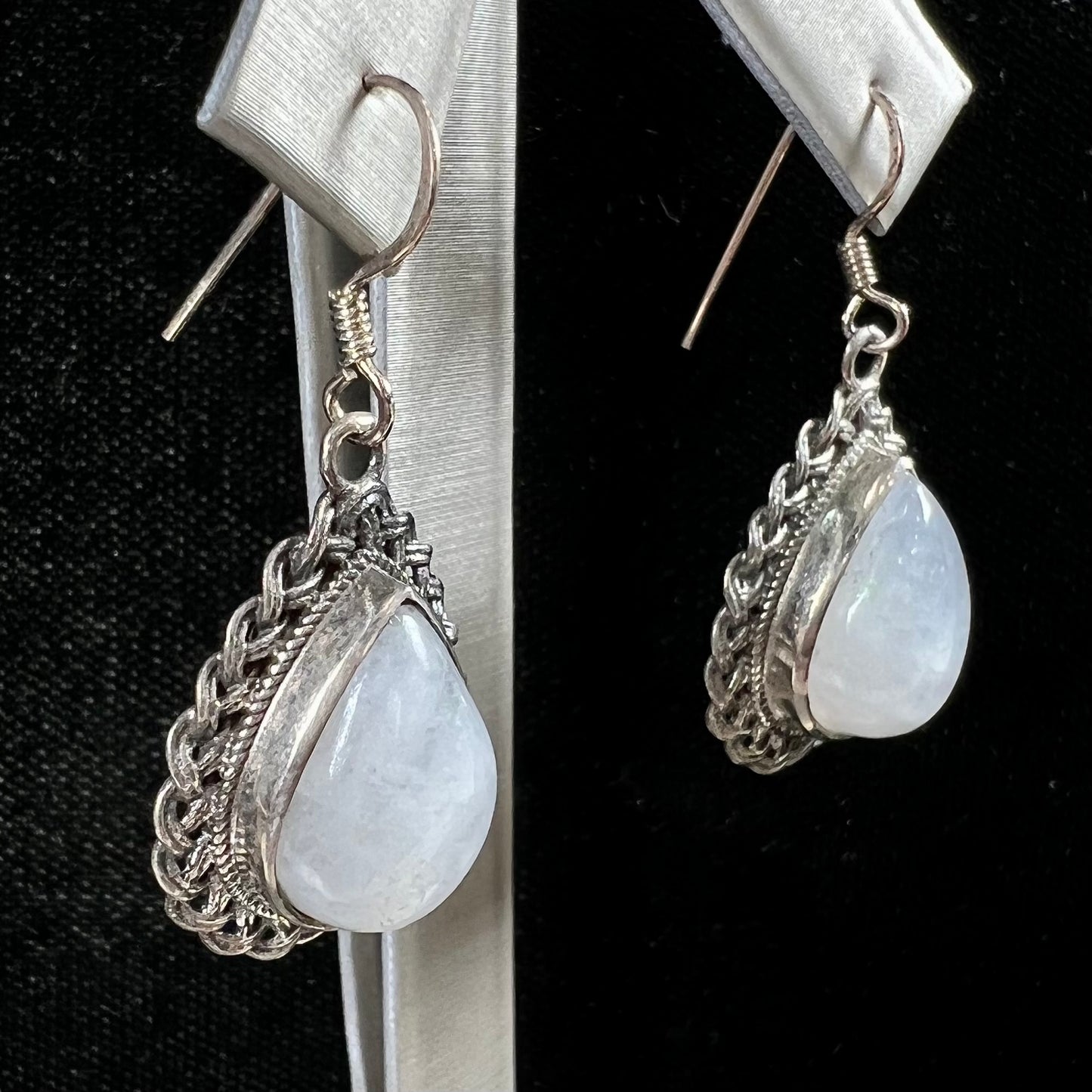 Silver filigree dangle wire earrings set with pear shape moonstones.