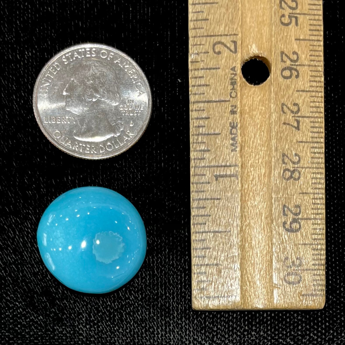 A loose, round cabochon cut turquoise stone from Sleeping Beauty Mine, Arizona.