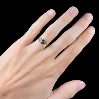 A natural blue sapphire and diamond baguette ring cast in yellow gold.