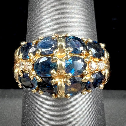 A vintage ladies' blue sapphire and diamond cluster ring cast in yellow gold.