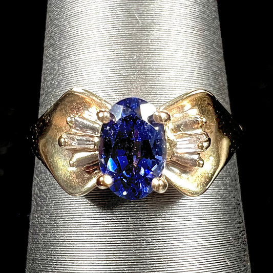 A natural blue sapphire and diamond baguette ring cast in yellow gold.