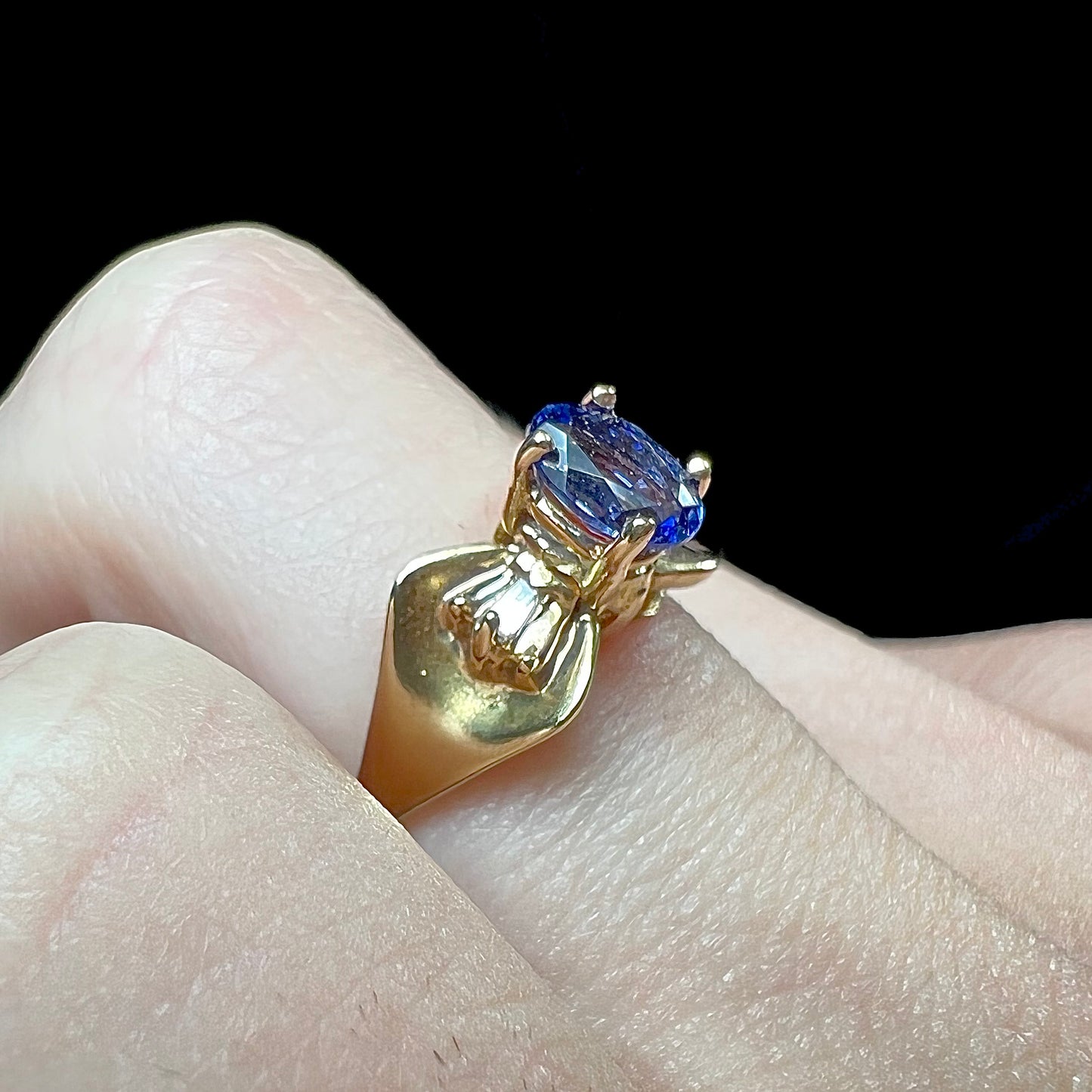 A natural blue sapphire and diamond baguette ring cast in yellow gold.
