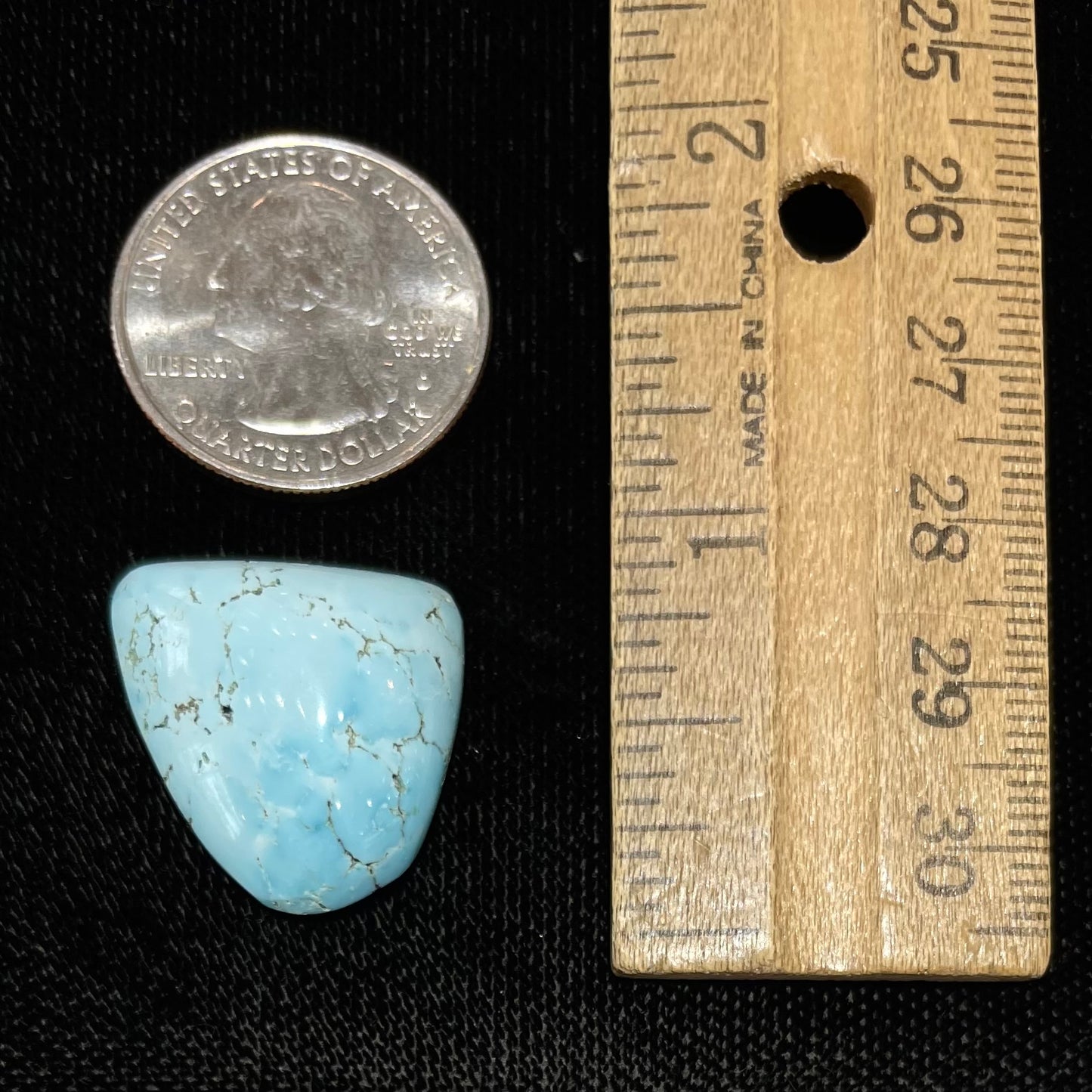 A loose, freeform cabochon cut light blue turquoise stone from Sleeping Beauty Mine, Arizona.