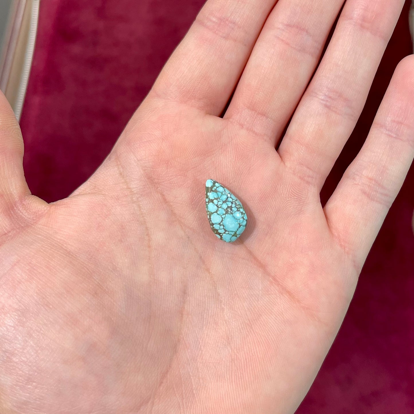 A loose, drop shaped turquoise stone from Number 8 Mine, Nevada.
