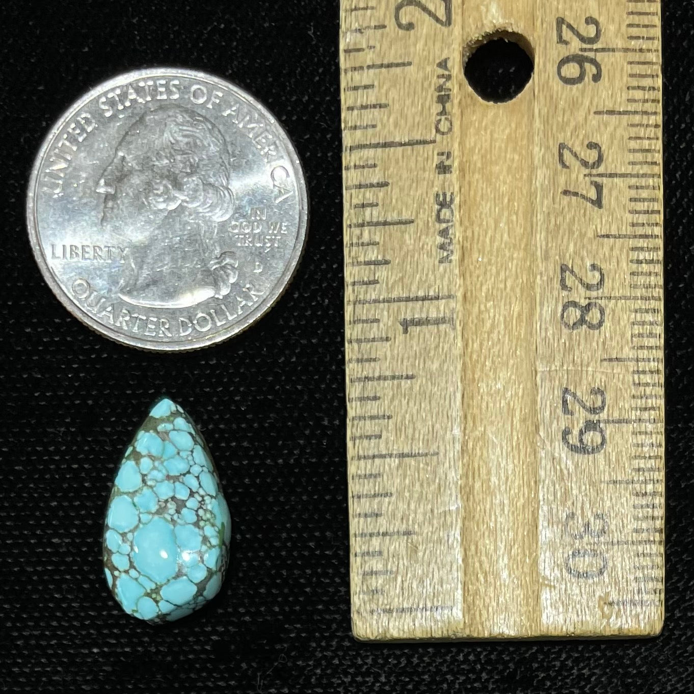 A loose, drop shaped turquoise stone from Number 8 Mine, Nevada.