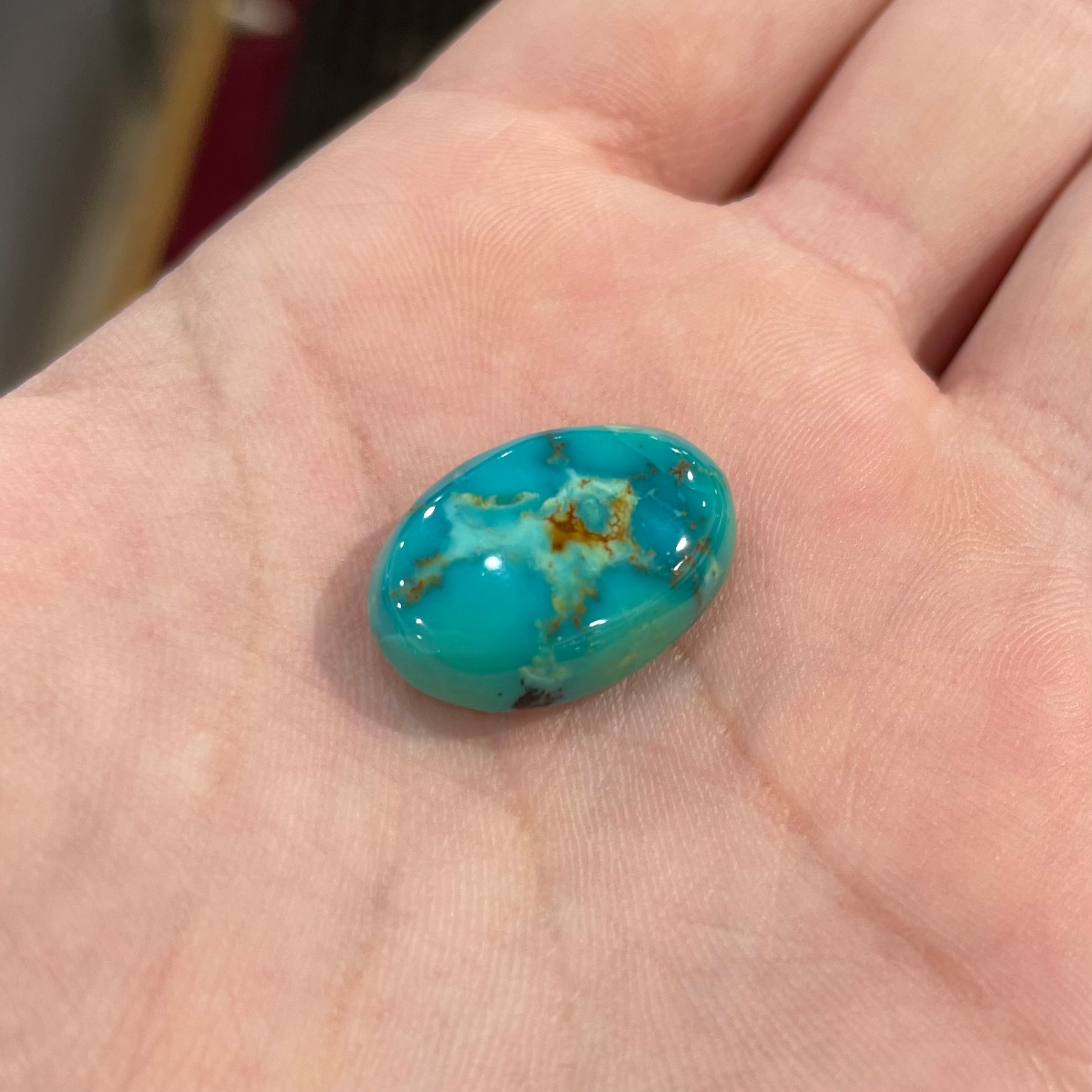 Loose Pilot Mountain turquoise with a pattern of brown matrix spots that resembles a star.  星绿松石