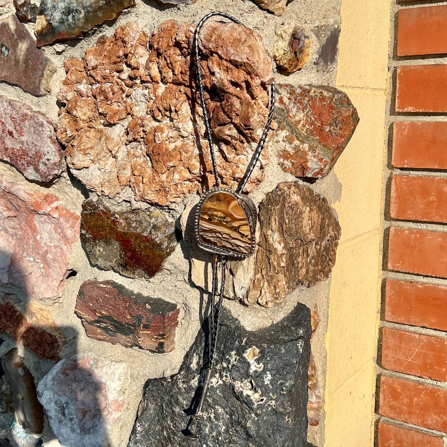 A men's sterling silver bolo tie set with a Biggs picture jasper stone.