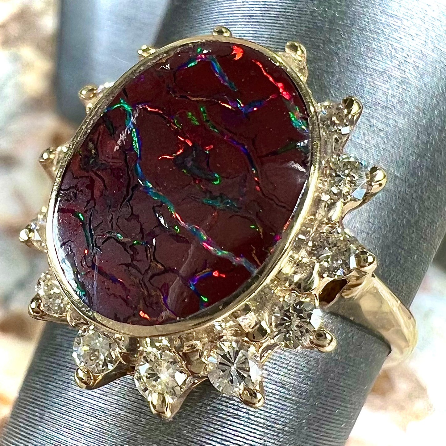 A ladies' diamond halo and Koroit boulder opal engagement ring.