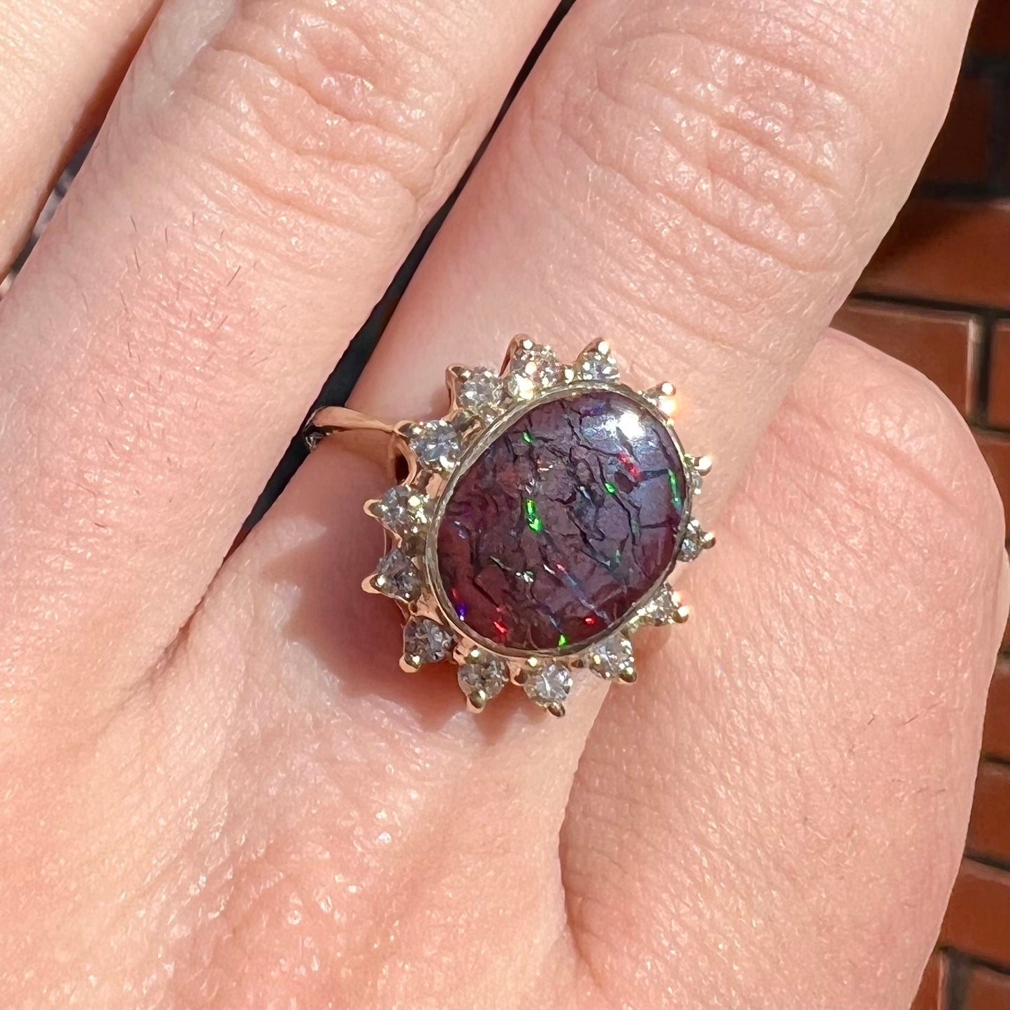 A ladies' diamond halo and Koroit boulder opal engagement ring.