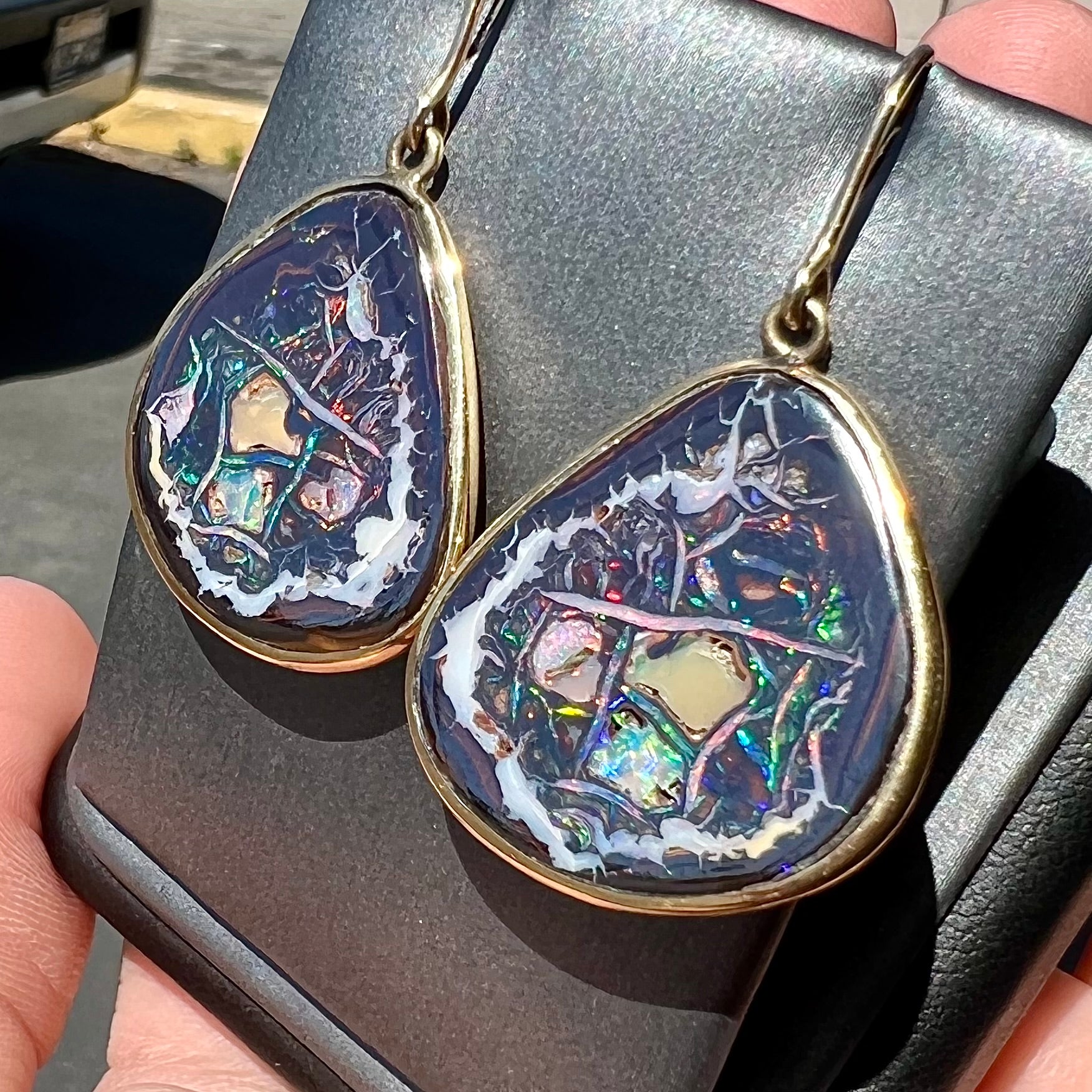 A pair of yellow gold bezel set Yowah nut boulder opal dangle earrings.