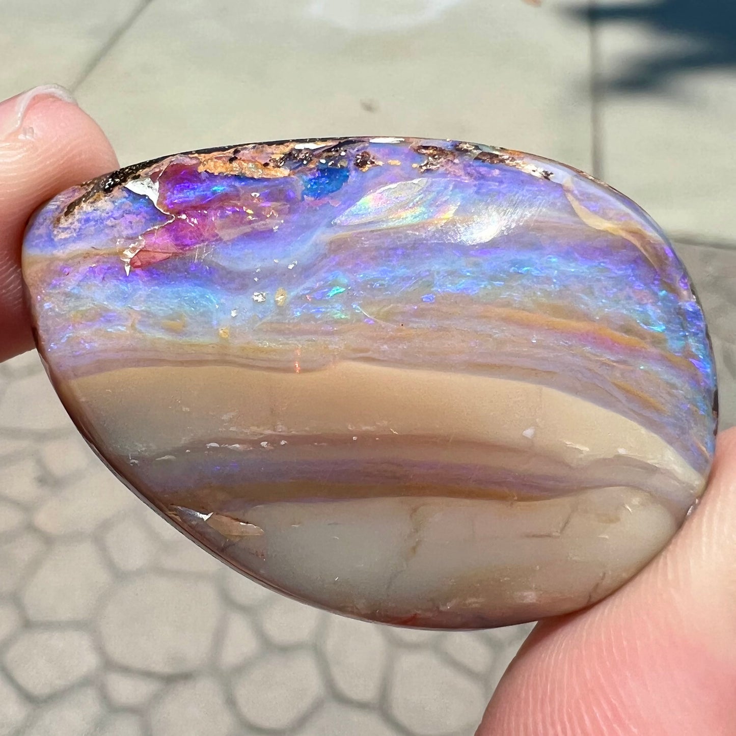 A loose, drop shaped Australian boulder opal from Quilpie Mining District.
