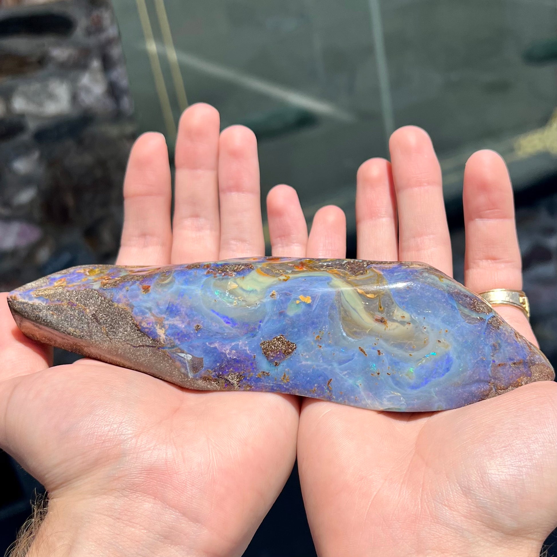 A 7 inch long polished blue Quilpie boulder opal specimen from Queensland, Australia.