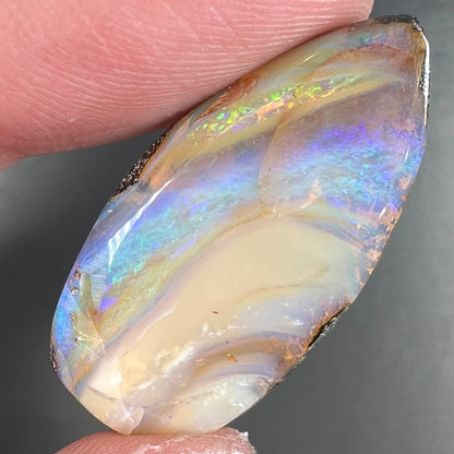A loose, pear shaped cabochon cut boulder opal stone from Quilpie, Australia.