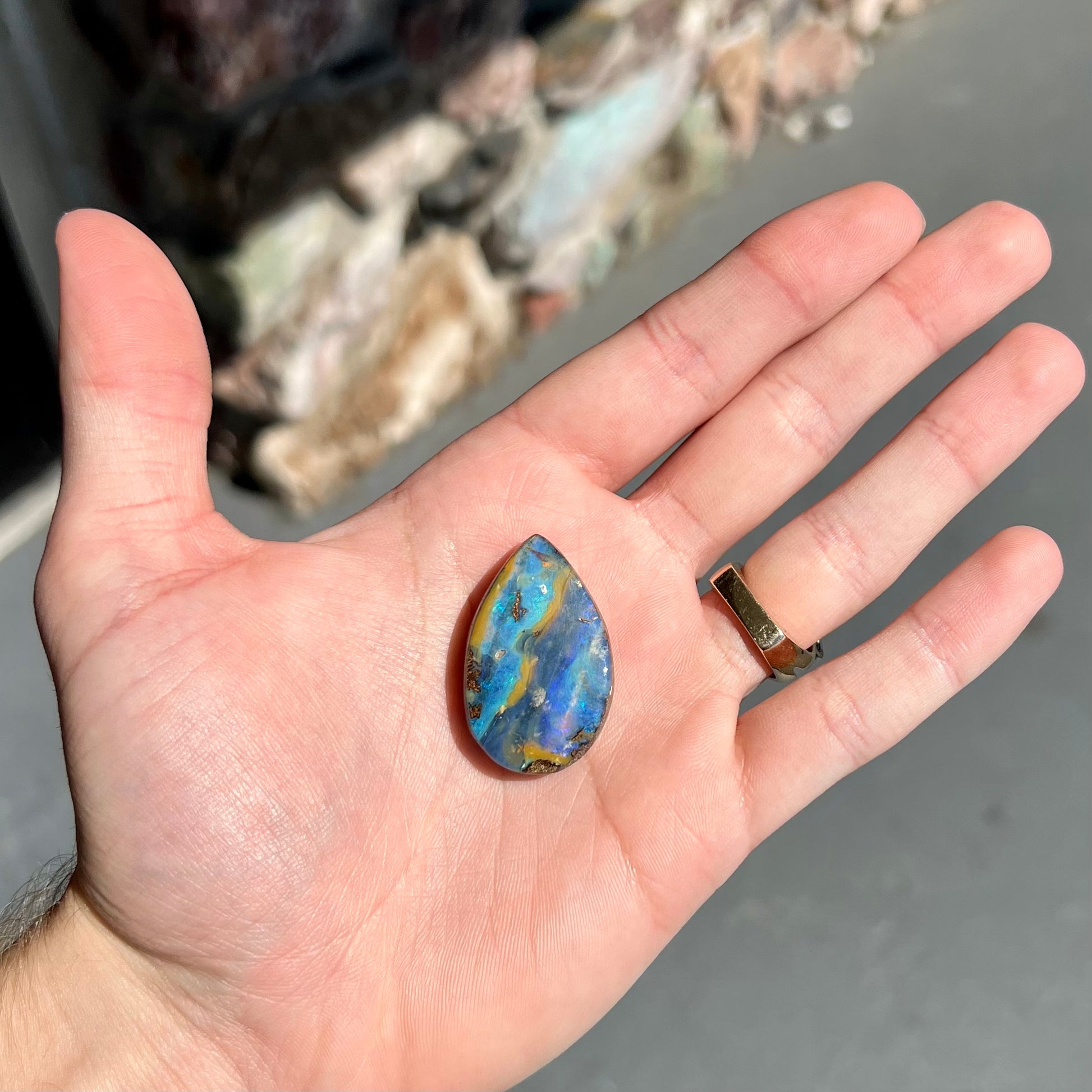 A loose, pear shaped cabochon cut boulder opal stone from Quilpie, Australia.