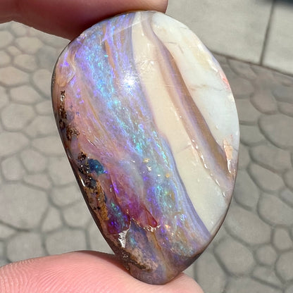A loose, drop shaped Australian boulder opal from Quilpie Mining District.