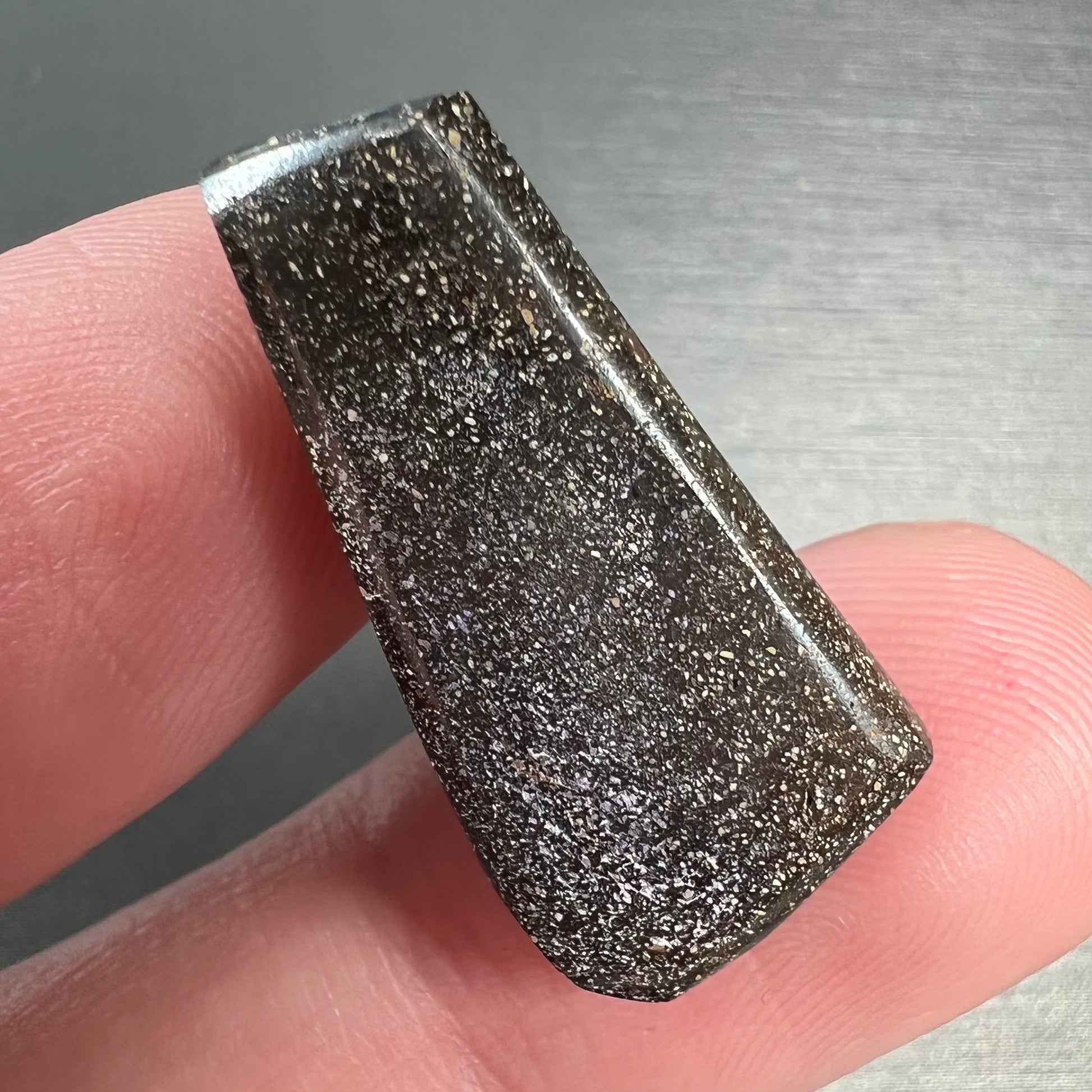A loose, freeform cut boulder opal stone from Quilpie, Australia.