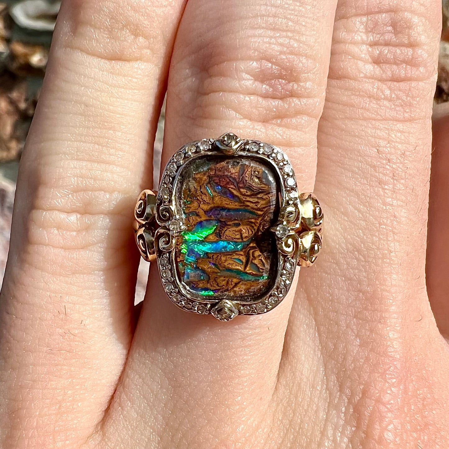 Striped Koroit boulder opal set in a filigree 14k yellow gold setting with diamonds.  The filigree has a heart pattern.