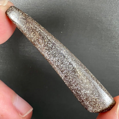 A loose, polished Quilpie boulder opal stone from Australia.  The stone is predominantly blue.