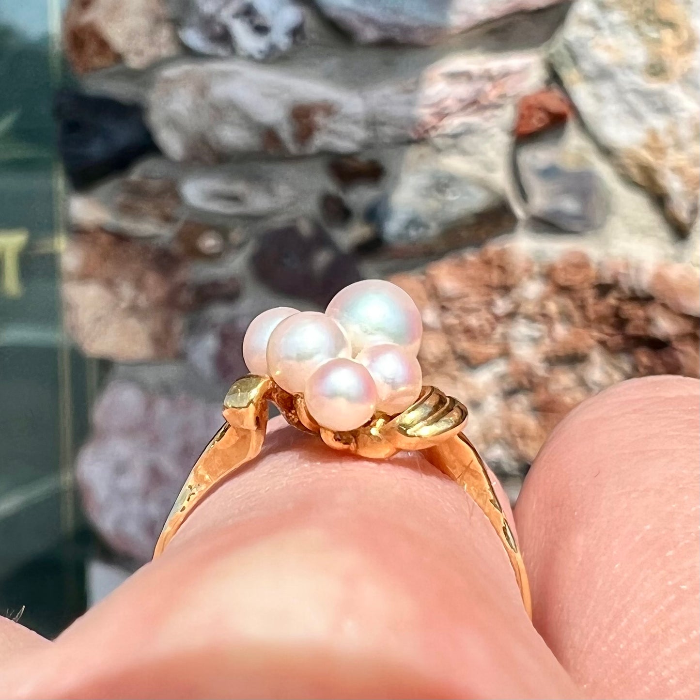 A yellow gold Akoya pearl cluster ring.  The pearls are round with pink overtones and resemble bubbles.