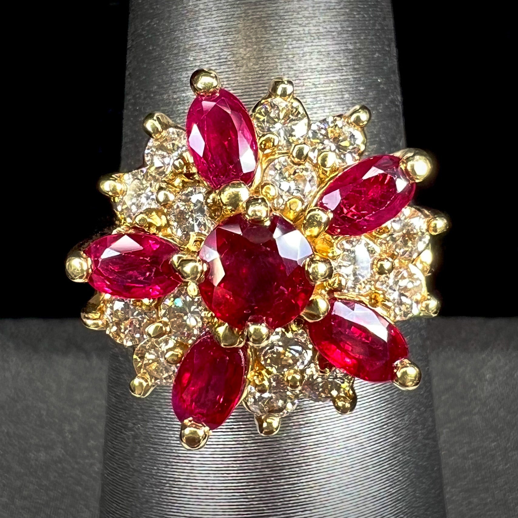 A ladies' vintage yellow gold cluster ring set with diamonds and pigeon blood red Burma rubies.