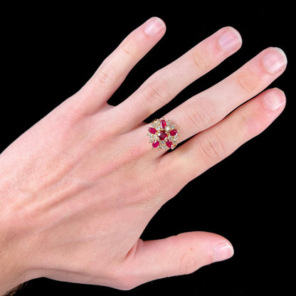 A ladies' vintage yellow gold cluster ring set with diamonds and pigeon blood red Burma rubies.