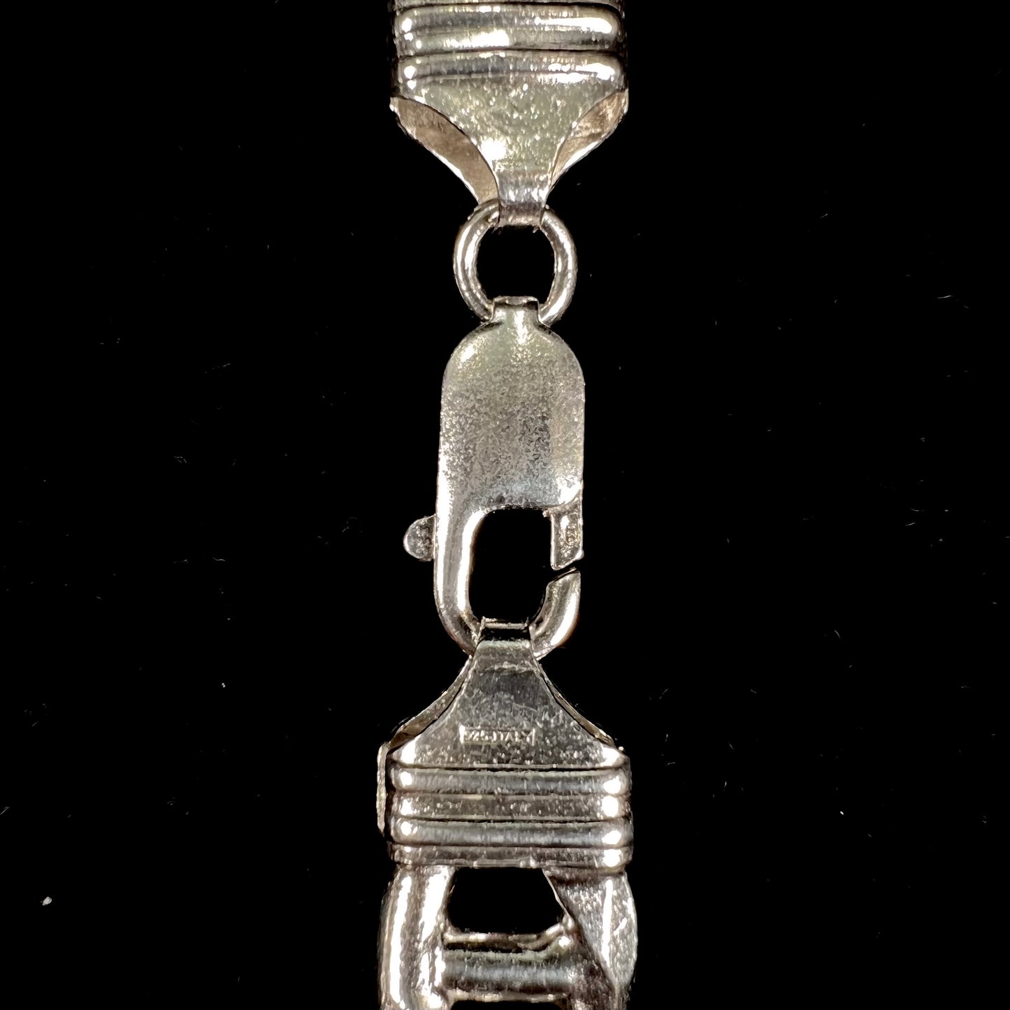 A men's sterling silver figaro anchor chain.  The chain measures 22 inches in length and the links are 11mm wide.