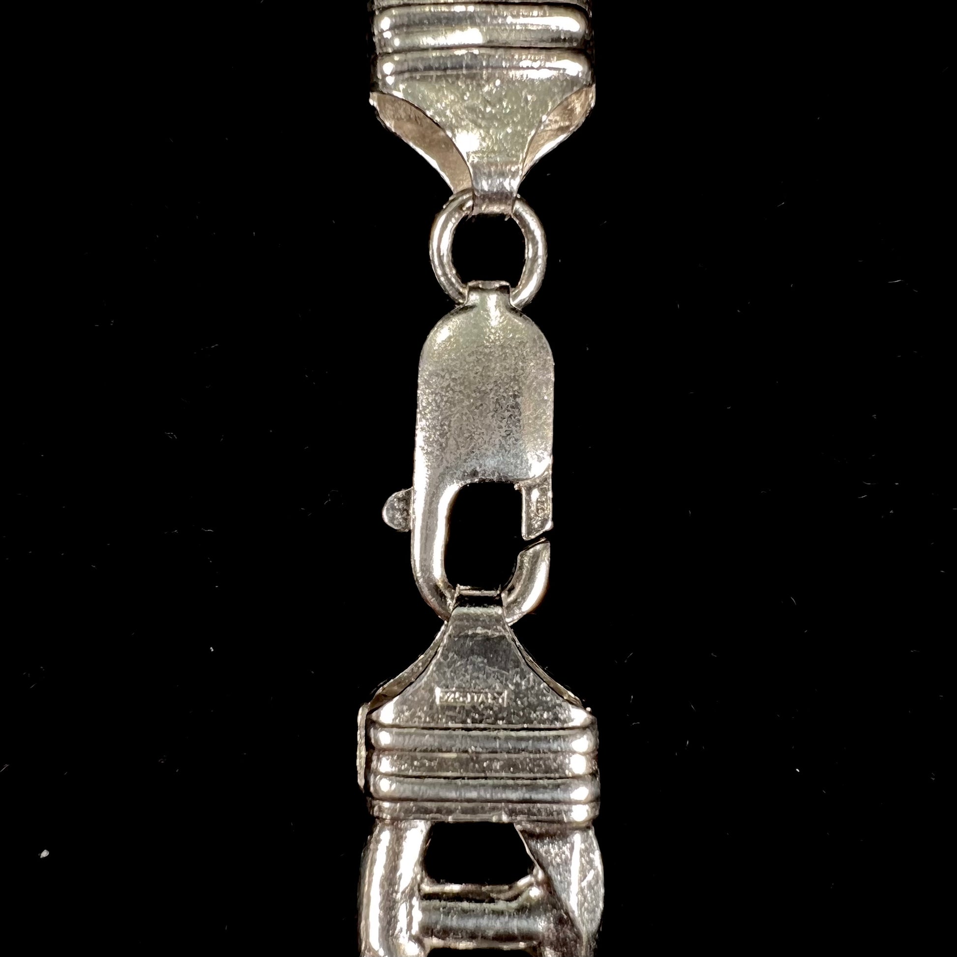 A men's sterling silver figaro anchor chain.  The chain measures 22 inches in length and the links are 11mm wide.