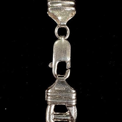 A men's sterling silver figaro anchor chain.  The chain measures 22 inches in length and the links are 11mm wide.